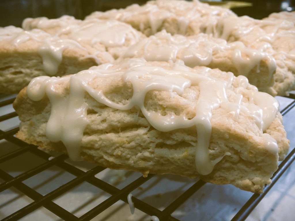 Lemon scones with drizzle glaze, close-up, by Crystal Smith