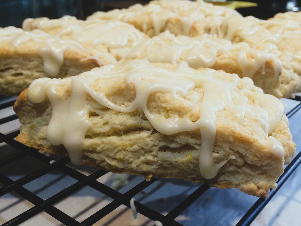 Lemon scones with lemon drizzle on a baking rack by Crystal Smith.