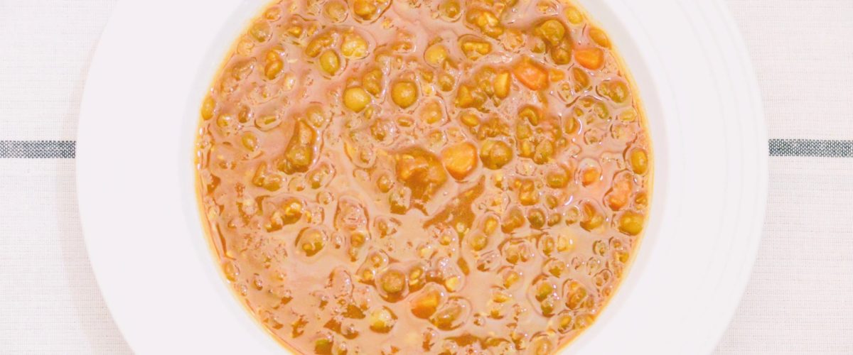 Spiced lentil soup in a white bowl by Crystal Smith.