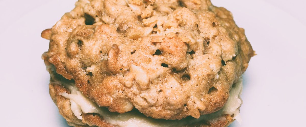Maple oat sandwich cookies, which consist of two oatmeal cookies with maple icing between them.