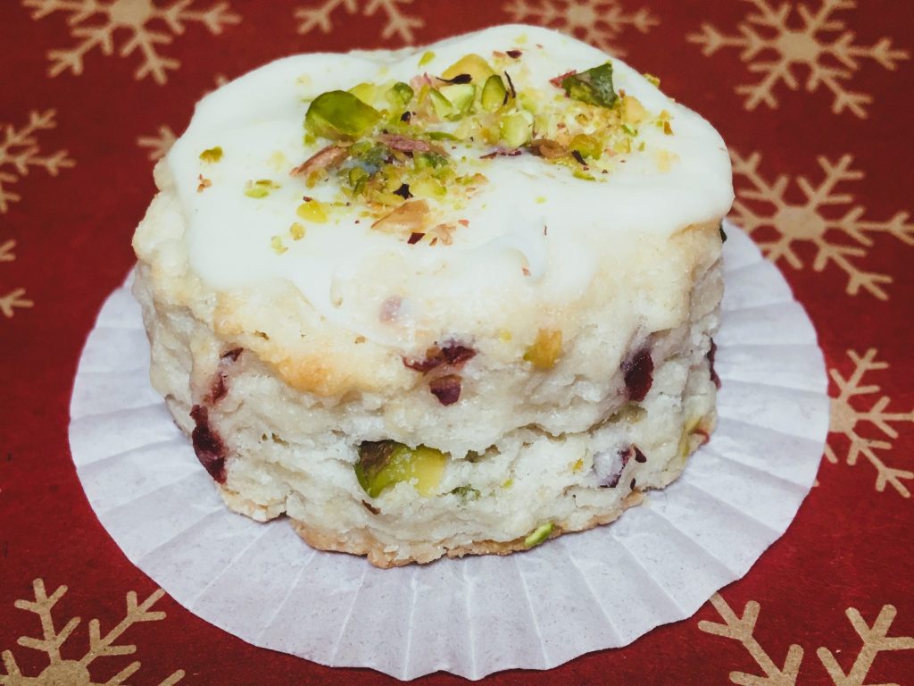 Cranberry and pistachio mini scone on a red Christmas background by Crystal Smith.