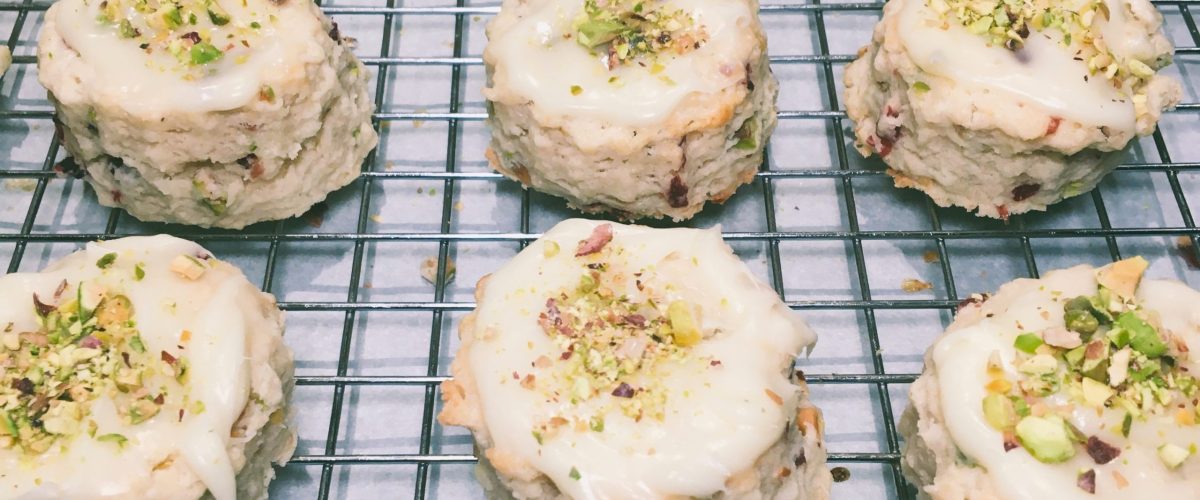 Pistachio and cranberry mini scones on a wire baking rack by Crystal Smith.