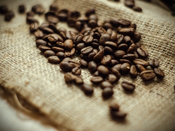 Coffee beans on burlap by Han Lahandoe on Unsplash.