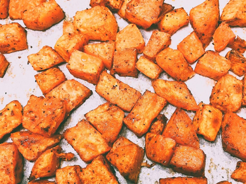 Roasted sweet potatoes on parchment paper.