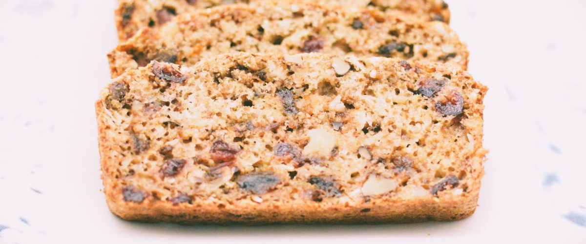 Quick loaf with dried fruit and walnuts on a white plate by Crystal Smith.